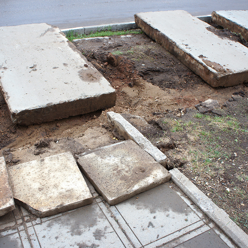Laying new tiles on sidewalk. Repair of concrete tiles